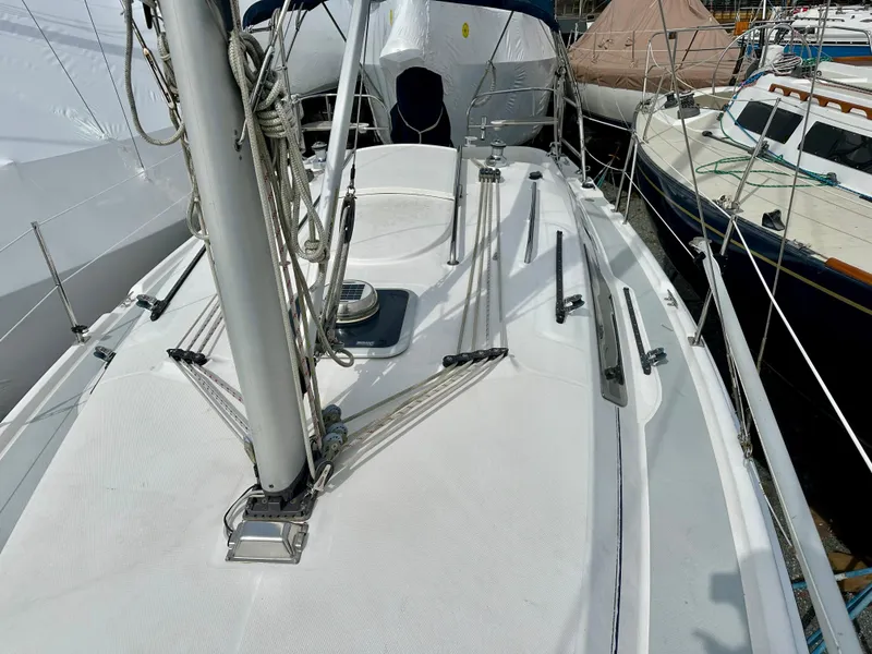 Slide: The Image of Furlex furling system on a 2006 Hunter 31 sailboat, docked with visible deck equipment. - 15