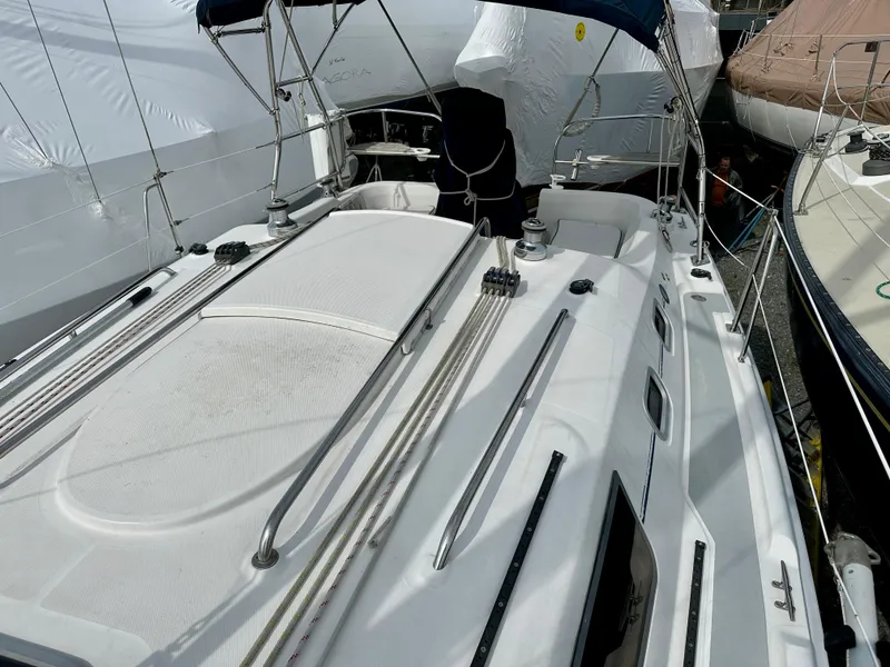 Slide: The Image of 2006 Hunter 31 sailboat deck view with mast and hatch, docked in a marina. - 17