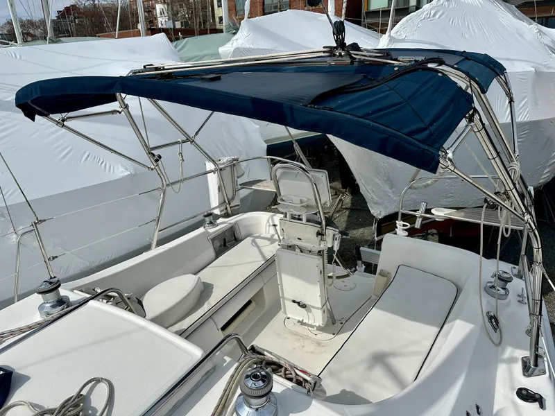 Slide: The Image of 2006 Hunter 31 sailboat deck with rigging and covered seating area. - 20