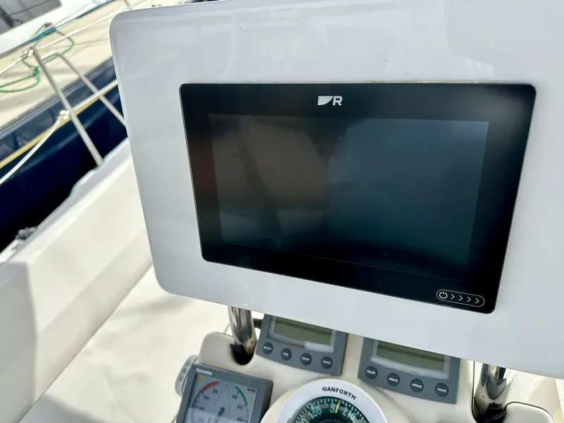 Slide: The Image of 2006 Hunter 31 sailboat deck view in marina, surrounded by other boats. - 22