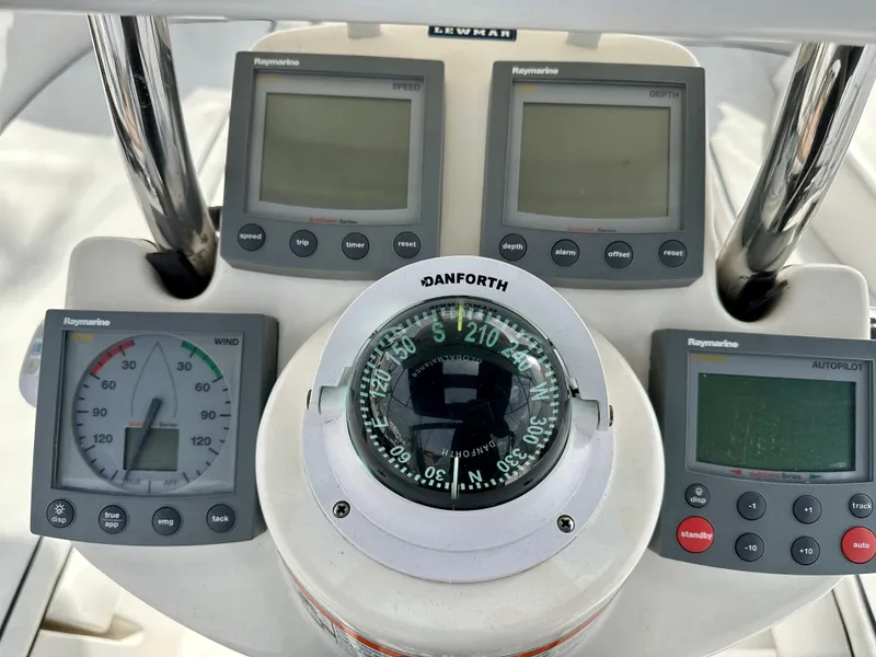 Slide: The Image of 2006 Hunter 31 sailboat cockpit with blue bimini top and covered seating area. - 23