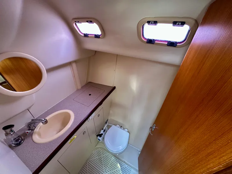 Slide: The Image of Boat navigation instruments on a 2006 Hunter 31, featuring compass and Raymarine displays. - 26