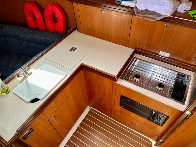 Slide: The Image of 2006 Hunter 31 yacht bathroom with sink, toilet, and portholes. - 29