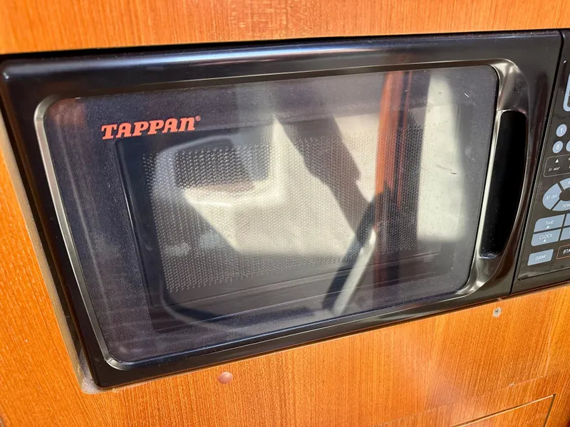 Slide: The Image of Interior of a 2006 Hunter 31 sailboat with seating, table, and kitchenette. - 32