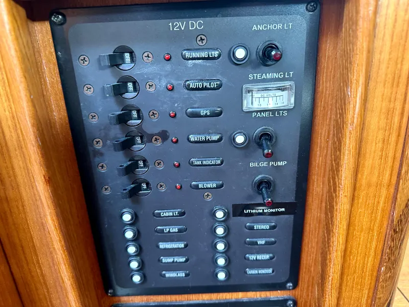 Slide: The Image of Navigation station in 2006 Hunter 31 sailboat with communication equipment and wooden finish. - 35