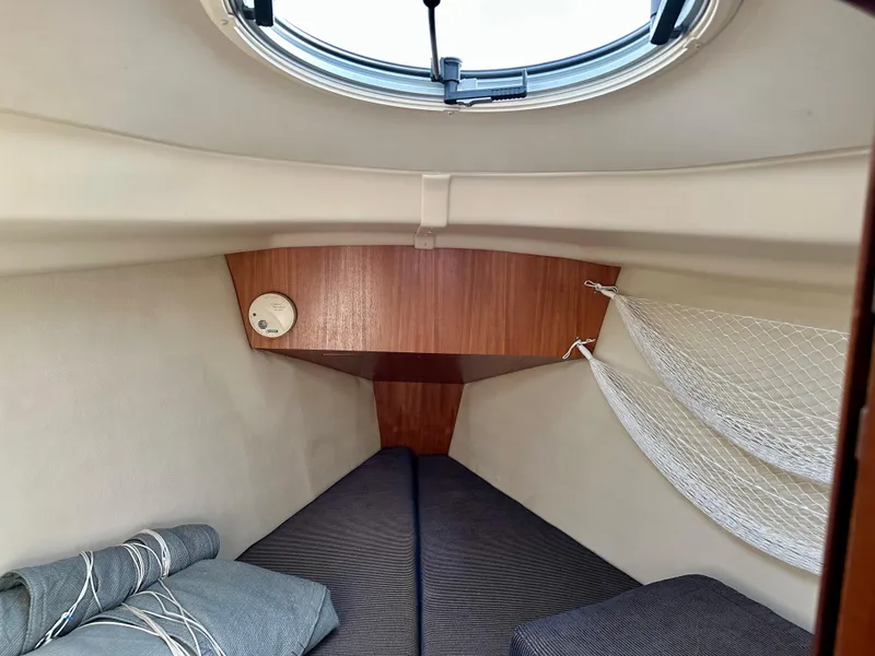 Slide: The Image of Cozy cabin interior of a 2006 Hunter 31 sailboat with bedding and storage net. - 41