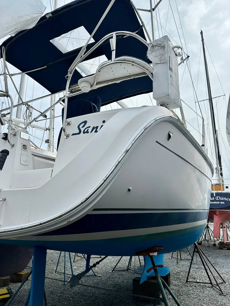 Slide: The Image of Blue keel of a 2006 Hunter 31 sailboat on gravel, supported by stands. - 48