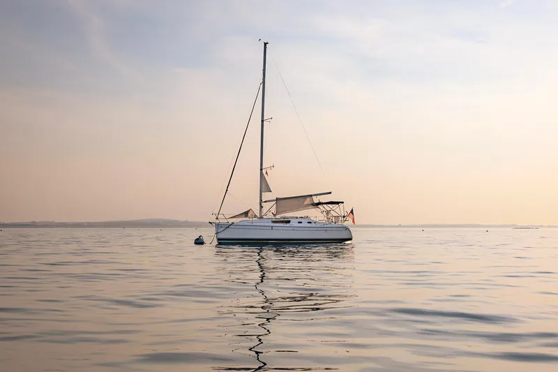 Slide: The Image of Sailing on a 2006 Hunter 31 yacht in calm waters at sunset. - 50