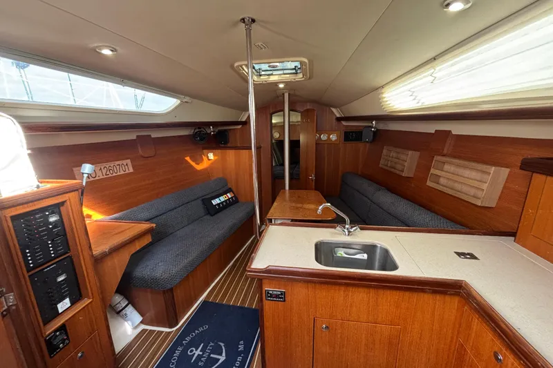 Slide: The Image of Interior of a 2006 Hunter 31 sailboat with wood finish and cozy seating. - 56