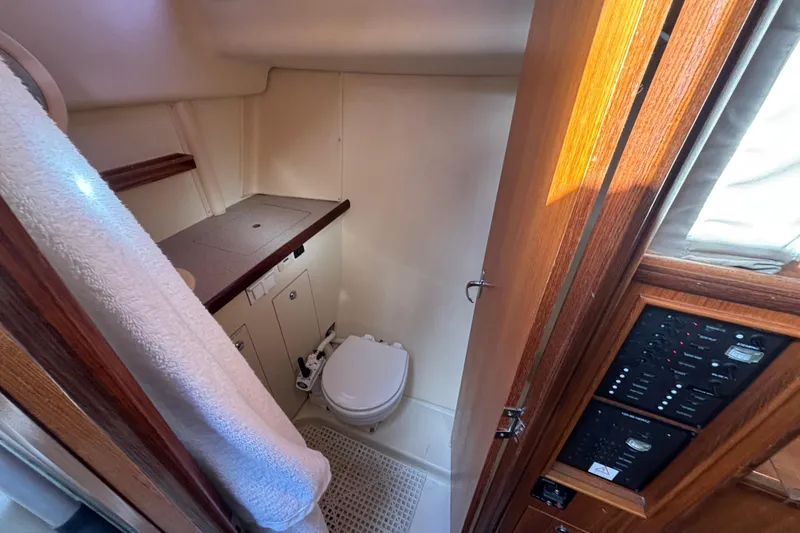 Slide: The Image of 2006 Hunter 31 yacht bathroom with wooden cabinetry and compact design. - 58