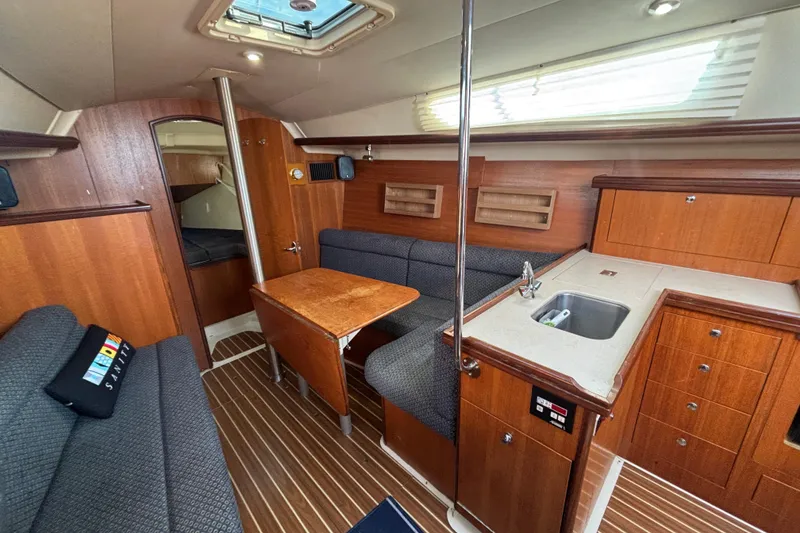 Slide: The Image of Interior of a 2006 Hunter 31 sailboat with wood finish and compact kitchen. - 59
