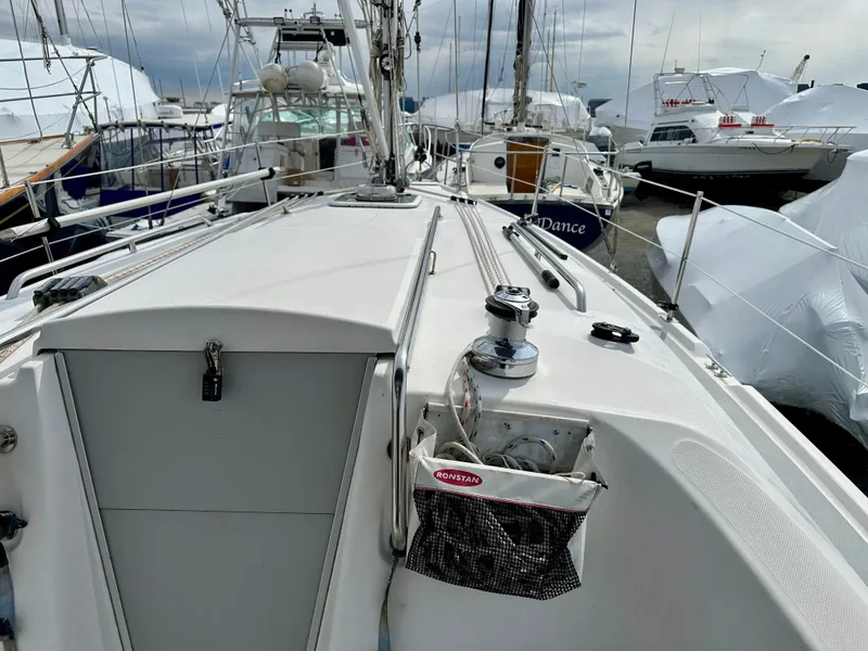 Slide: The Image of Interior of a 2006 Hunter 31 sailboat with wood finish and seating area. - 6