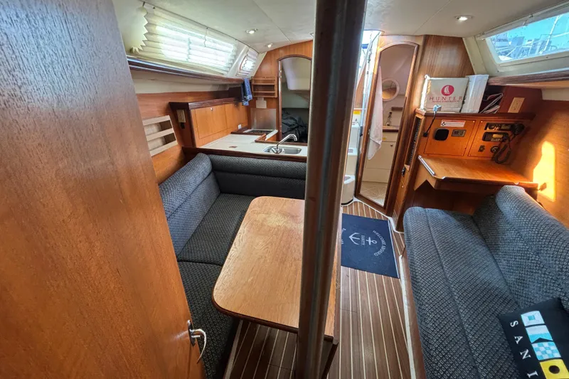 Slide: The Image of Interior of 2006 Hunter 31 sailboat with wood finish and cozy seating area. - 63