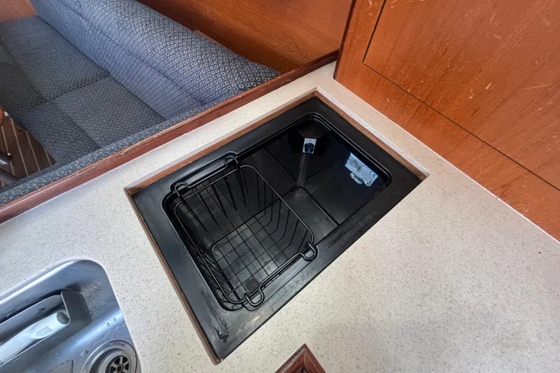 Slide: The Image of Galley sink area in 2006 Hunter 31 sailboat with countertop and seating. - 65