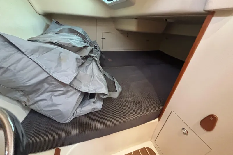 Slide: The Image of 2006 Hunter 31 interior cabin with storage and gray cover. - 66