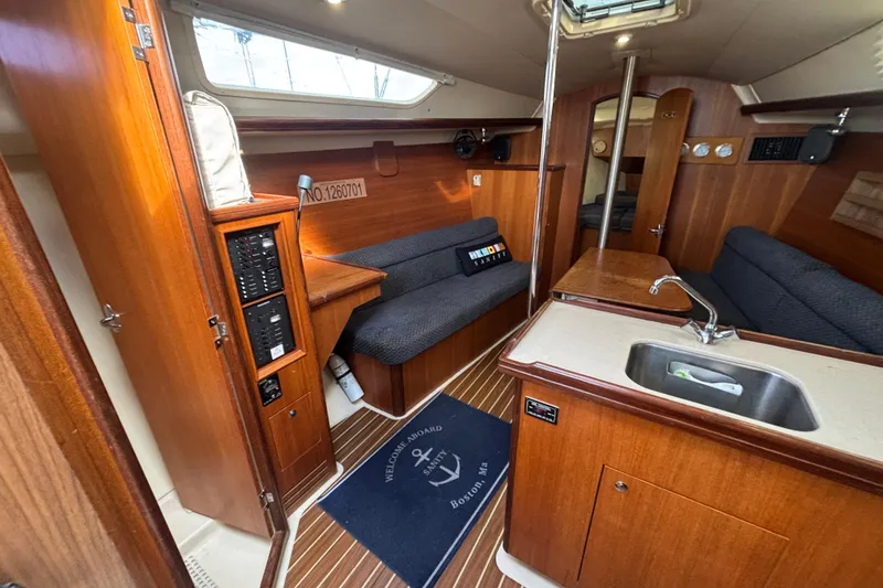 Slide: The Image of Interior of a 2006 Hunter 31 sailboat with wood finish and compact kitchen area. - 67