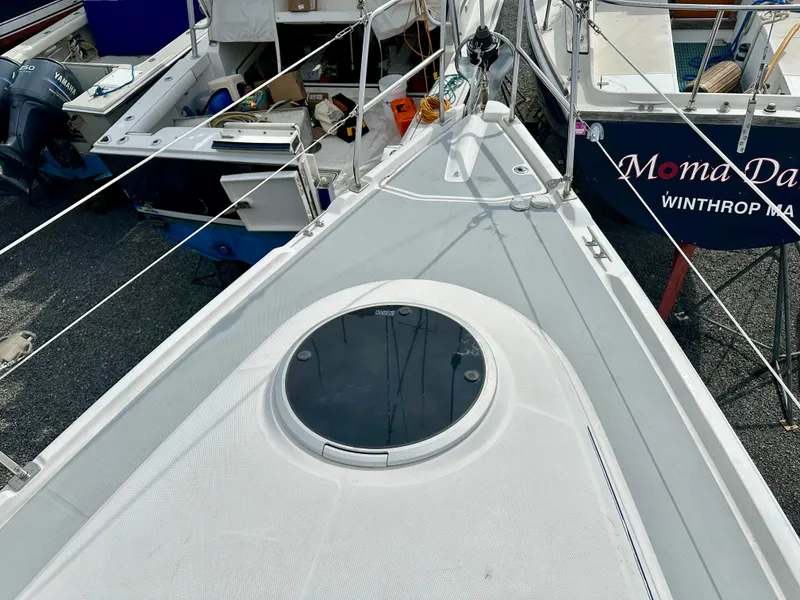 Slide: The Image of 2006 Hunter 31 sailboat deck view in marina, surrounded by other boats. - 9