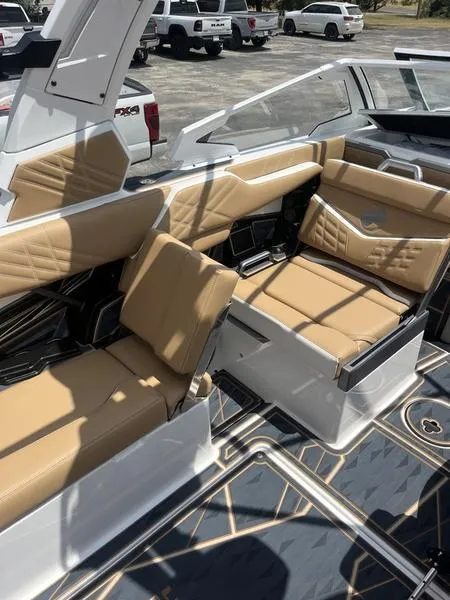 Slide: The Image of 2025 Tigé Ultré 25ZX boat interior with tan leather seating and modern design. - 4
