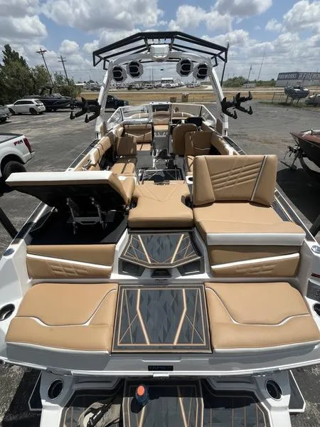 Slide: The Image of 2025 Tigé Ultré 25ZX boat with luxurious tan seating and modern design. - 6