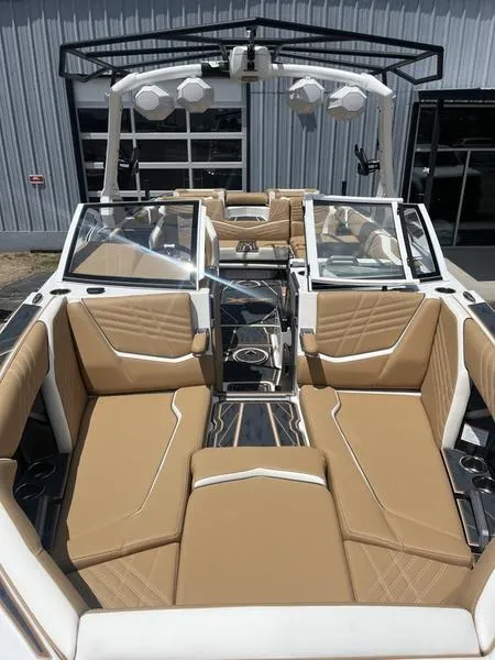 Slide: The Image of 2025 Tigé Ultré 25ZX boat interior with tan leather seating and modern design. - 7