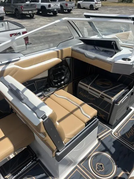 Slide: The Image of 2025 Tigé Ultré 25ZX boat interior with tan seating and modern dashboard. - 8
