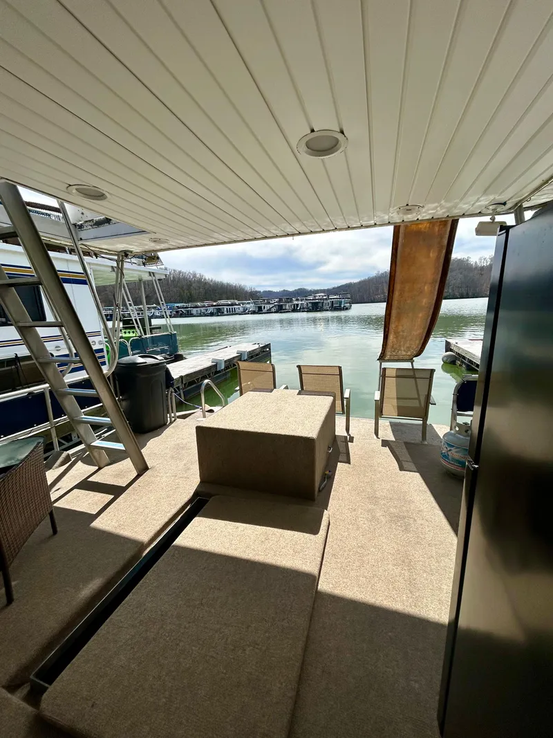 Slide: The Image of 1987 Jamestowner houseboat deck with seating, overlooking serene lake view. - 22