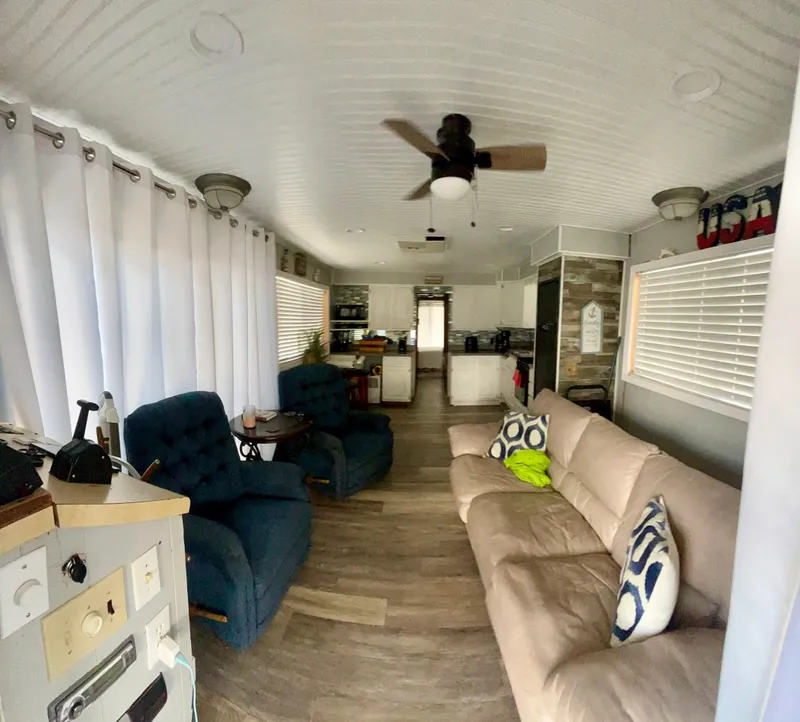 Slide: The Image of Interior of a 1987 Jamestowner houseboat with cozy seating and modern decor. - 6