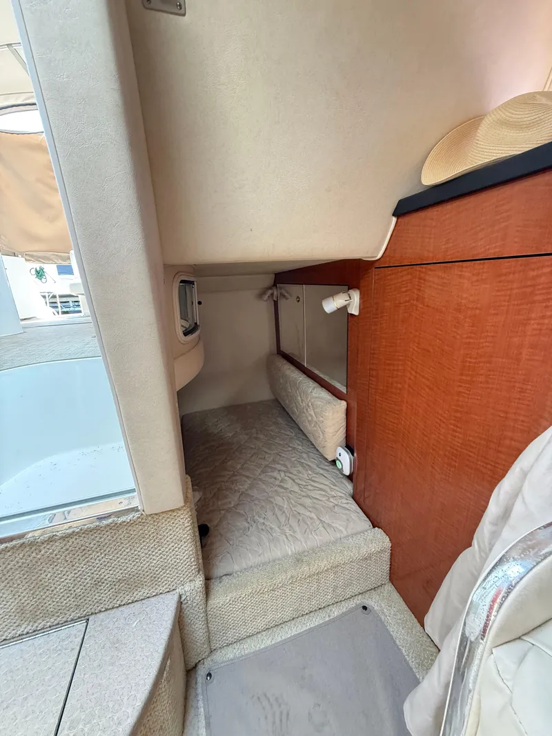 Slide: The Image of Interior cabin of 2004 Sea Ray 280 Sundancer with cozy sleeping area. - 12