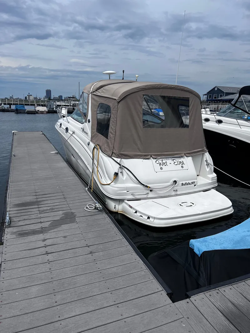 Slide: The Image of 2004 Sea Ray 280 Sundancer docked at marina under cloudy sky. - 4