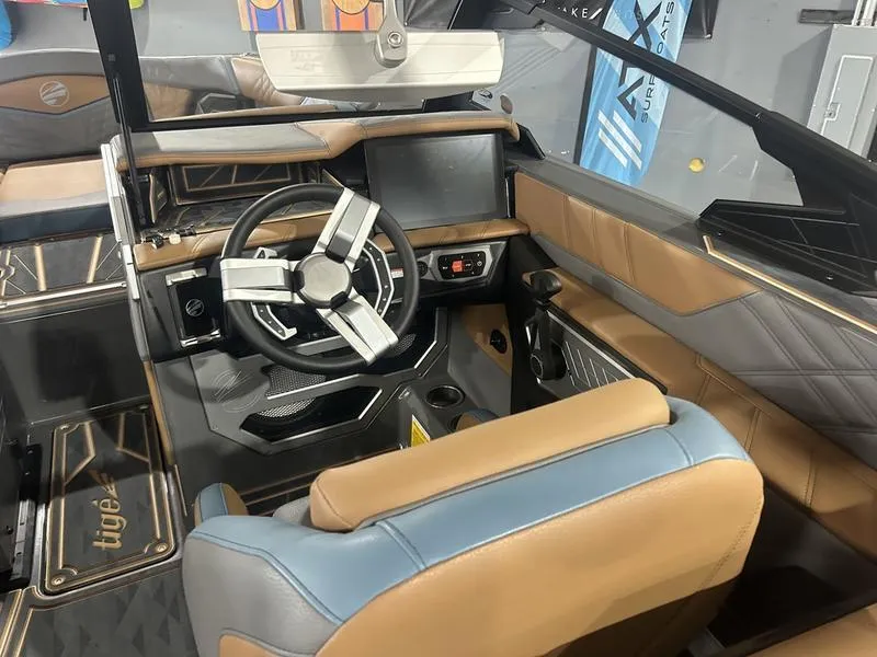 Slide: The Image of 2025 Tigé Ultré 25ZX boat interior with modern steering and dashboard design. - 3