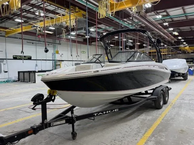 Slide: The Image of 2024 Tahoe 210 S boat on trailer in a warehouse setting. - 1