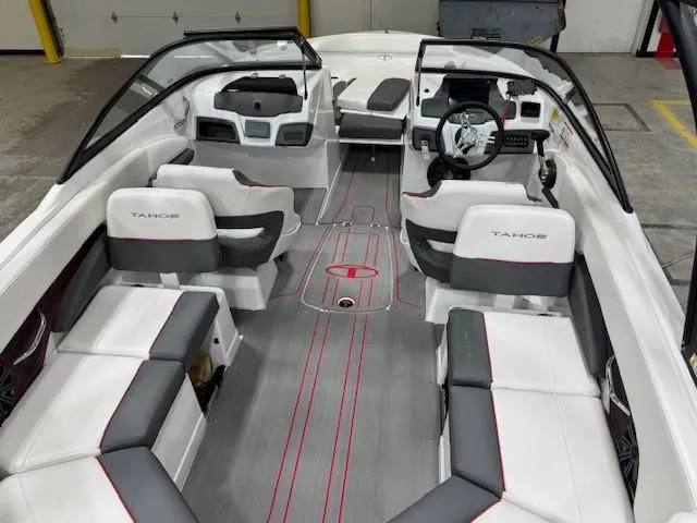 Slide: The Image of 2024 Tahoe 210 S boat interior with white and gray seating, modern dashboard, and spacious layout. - 3
