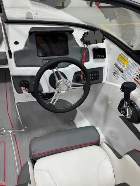Slide: The Image of 2024 Tahoe 210 S boat interior with steering wheel and control panel. - 4