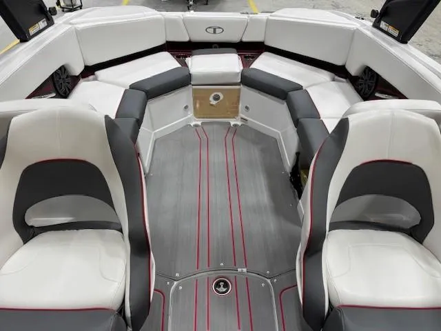 Slide: The Image of 2024 Tahoe 210 S boat interior with white and gray seating, red accents, and spacious layout. - 6