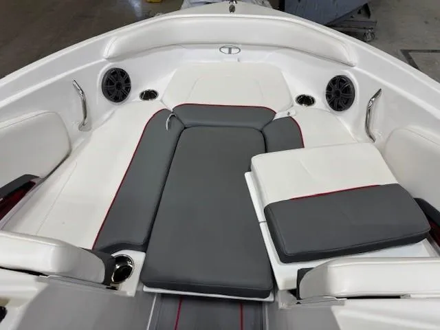 Slide: The Image of 2024 Tahoe 210 S boat interior with gray and white seating, speakers, and cup holders. - 9