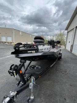 Slide: The Image of 2020 Ranger RT198P boat on trailer, parked outside industrial building under cloudy sky. - 8