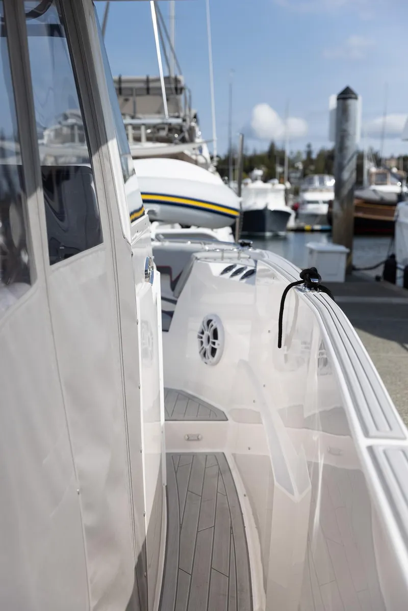 Slide: The Image of 2026 Solara S-310 CW boat docked at marina, showcasing sleek design and modern features. - 18