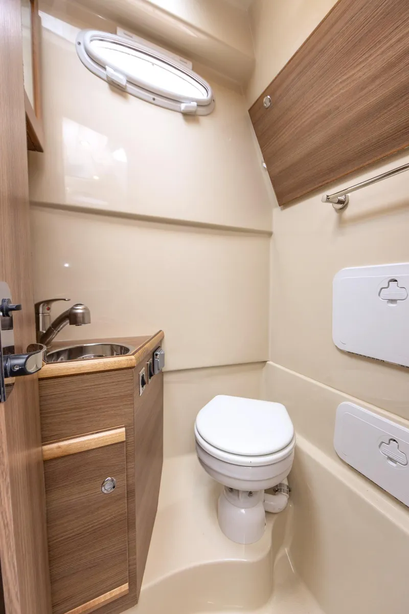 Slide: The Image of Compact bathroom in 2026 Solara S-310 CW boat with modern fixtures and wood accents. - 28
