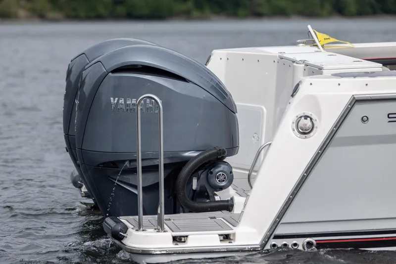 Slide: The Image of Outboard motor on a 2026 Solara S-310 CW boat in water. - 31