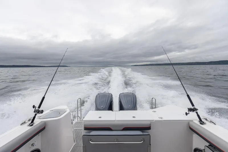 Slide: The Image of 2026 Solara S-310 CW boat cruising on open water with fishing rods. - 32