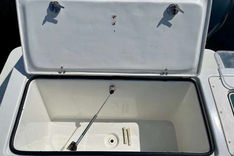 Slide: The Image of Open storage compartment on 2016 Parker 2501 Center Console boat. - 10