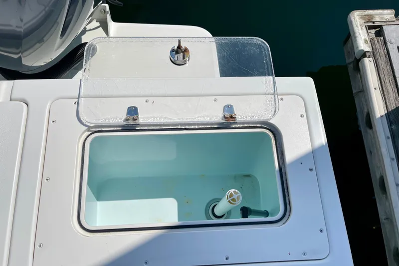Slide: The Image of Open livewell on 2016 Parker 2501 Center Console boat, dockside view. - 12