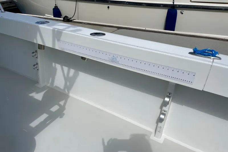 Slide: The Image of 2016 Parker 2501 Center Console boat interior with measuring ruler on side panel. - 16