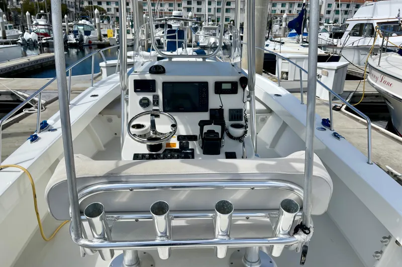 Slide: The Image of 2016 Parker 2501 Center Console boat interior with steering wheel and control panel at marina. - 17