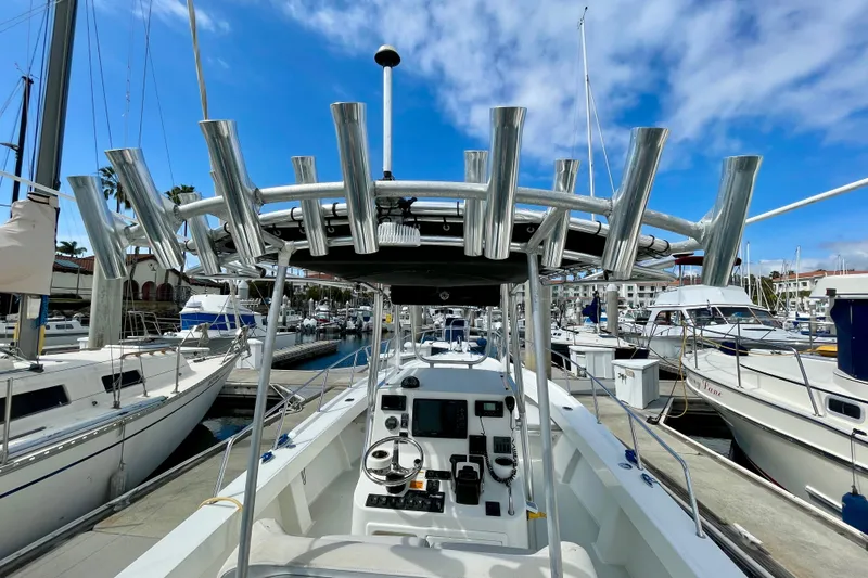 Slide: The Image of 2016 Parker 2501 Center Console boat docked at marina under blue sky. - 18