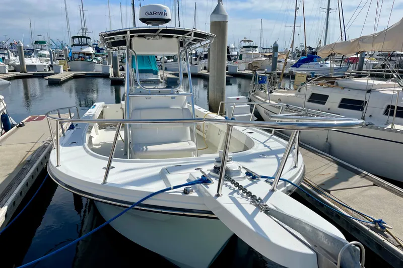 Slide: The Image of 2016 Parker 2501 Center Console boat docked in a marina. - 2
