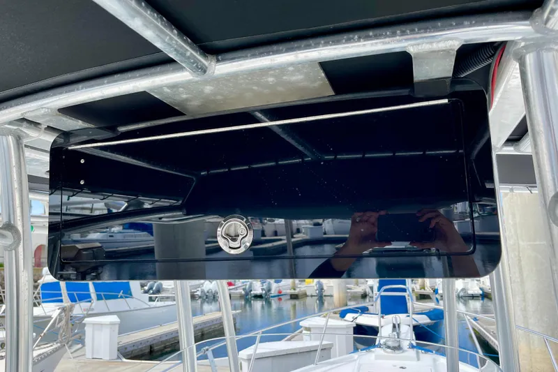 Slide: The Image of 2016 Parker 2501 Center Console boat with sleek black console at marina. - 21