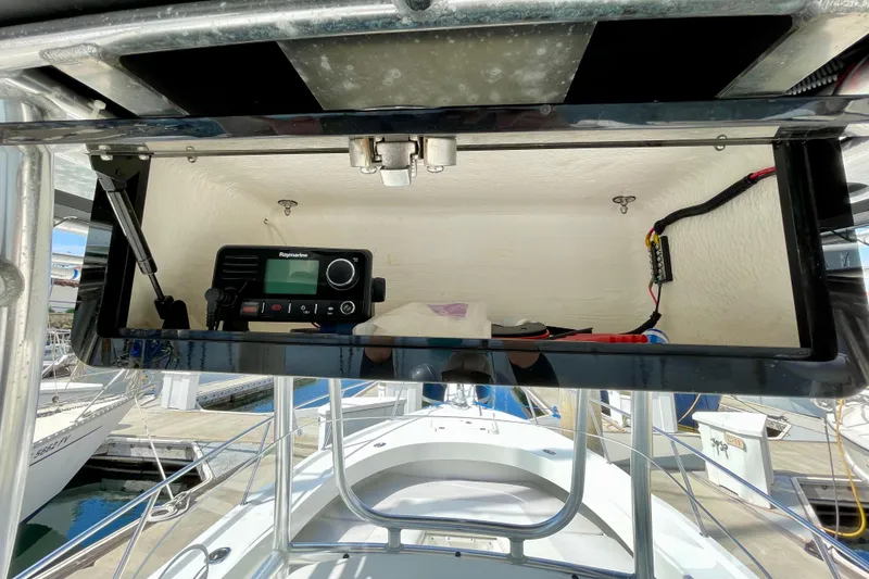 Slide: The Image of 2016 Parker 2501 Center Console boat with open electronics compartment at marina. - 22