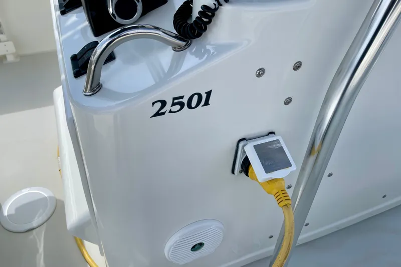 Slide: The Image of 2016 Parker 2501 Center Console boat dashboard with steering wheel and power connection. - 23