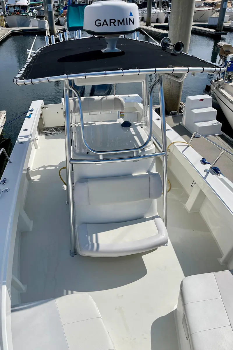 Slide: The Image of 2016 Parker 2501 Center Console boat with Garmin equipment, docked at a marina. - 26